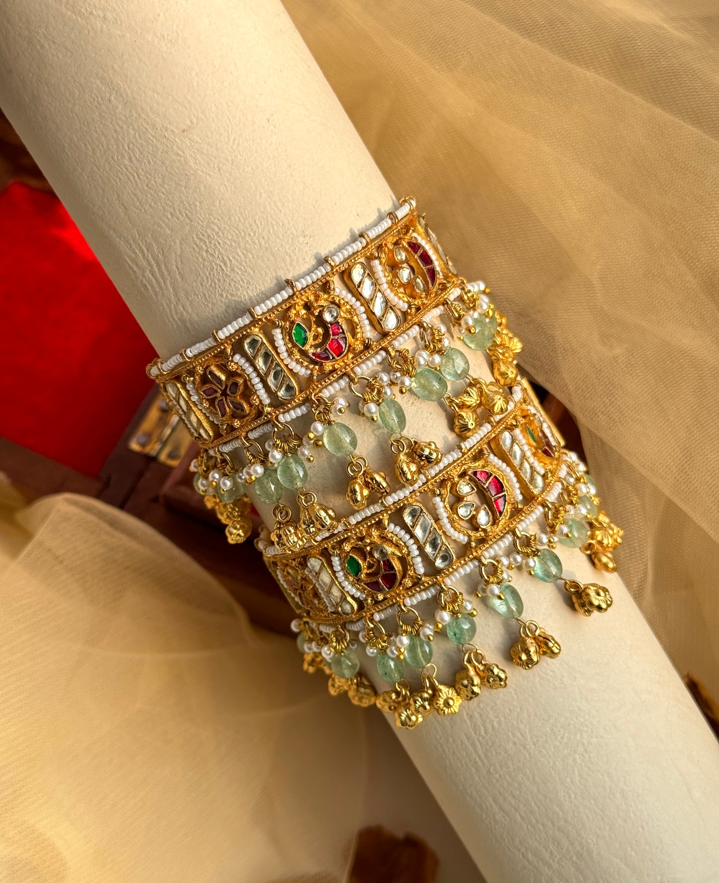 Traditional gold plated kada hanging with a floral motif